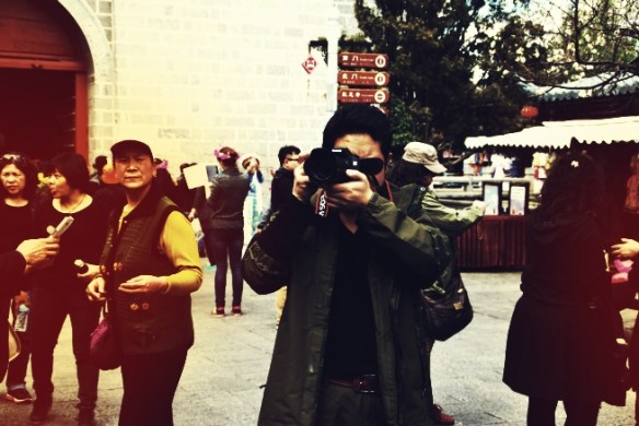 Here’s a man that I photographed pretending to take pictures of something behind us. He quickly refocused his lens on something else when I pointed my camera at him.